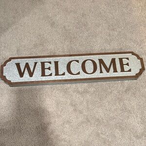 Brown and Silver Welcome Sign